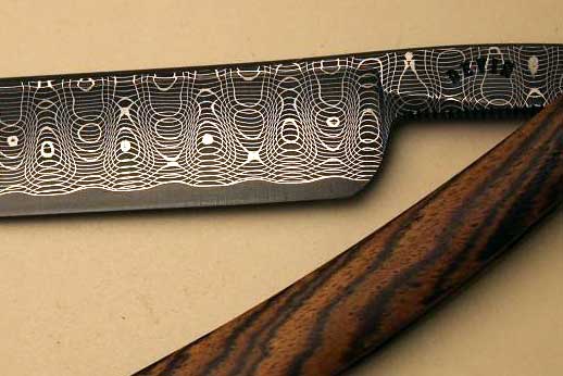 7/8 1/4 hollow spirograph damascus with solid edge and bocote handle.