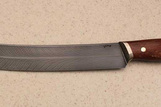 11.5"blade with Australian lace wood handle and mokume guard. Stainless feather pattern damascus in the blade.