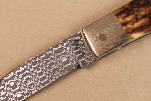 Damascus Folder with Mokume bolster, endcap and mammoth bone handle.